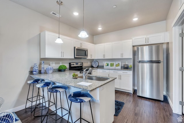 265 N 670 E, Vineyard, UT 84059 - kitchen with white cabinets, a sink, visible vents, stainless steel appliances, and a peninsula