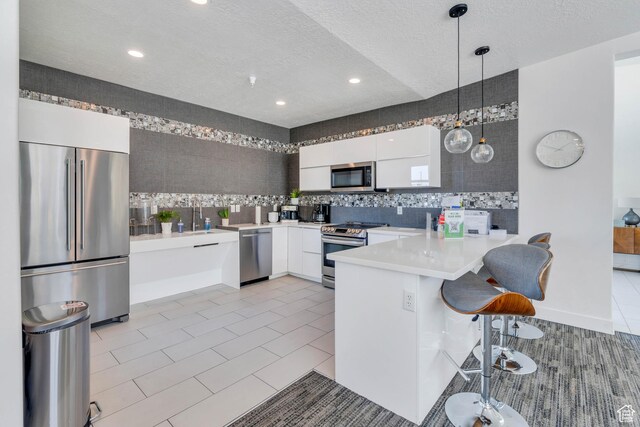 265 N 670 E, Vineyard, UT 84059 - kitchen with appliances with stainless steel finishes, white cabinetry, modern cabinets, and a peninsula