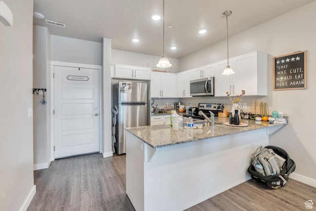 265 N 670 E, Vineyard, UT 84059 - kitchen featuring light stone countertops, stainless steel appliances, visible vents, a peninsula, and wood finished floors