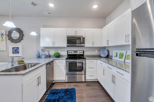 265 N 670 E, Vineyard, UT 84059 - kitchen featuring a peninsula, a sink, appliances with stainless steel finishes, and white cabinetry