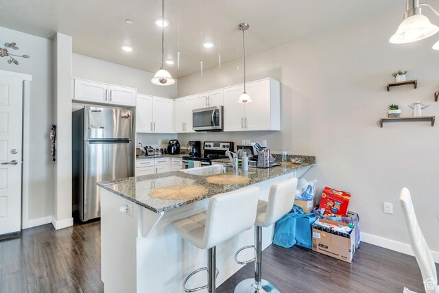 265 N 670 E, Vineyard, UT 84059 - kitchen with stainless steel appliances, a peninsula, light stone counters, baseboards, and white cabinets