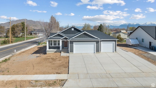 292 500 N, Santaquin, UT 84655 - view of front of house with driveway, board and batten siding, a mountain view, and an attached garage
