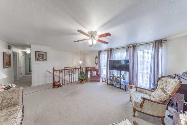 27 E Monticello Dr S, Kaysville, UT 84037 - sitting room with ceiling fan, carpet flooring, an upstairs landing, and a textured ceiling