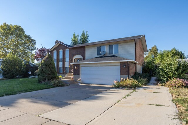 27 E Monticello Dr S, Kaysville, UT 84037 - raised ranch with a garage, brick siding, a chimney, and concrete driveway