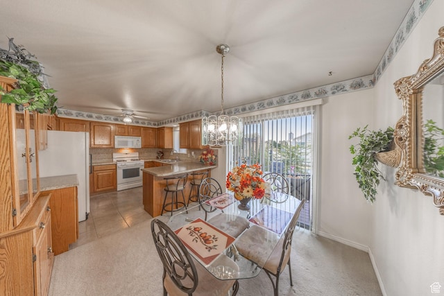27 E Monticello Dr S, Kaysville, UT 84037 - dining room featuring baseboards, an inviting chandelier, light colored carpet, and light tile patterned flooring