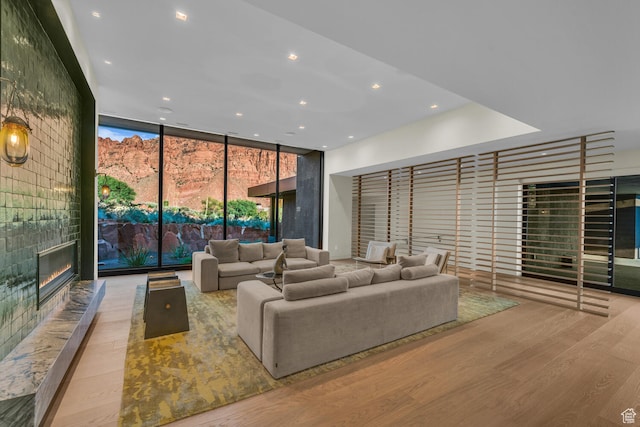 973 W Sipala Trl, Ivins, UT 84738 - living room with a wall of windows, a large fireplace, and light wood-type flooring