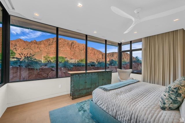 973 W Sipala Trl, Ivins, UT 84738 - bedroom with ceiling fan, a mountain view, floor to ceiling windows, and light hardwood / wood-style floors