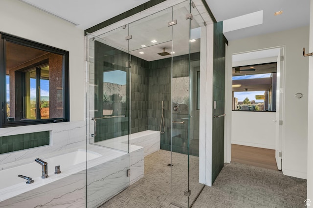 973 W Sipala Trl, Ivins, UT 84738 - bathroom featuring a skylight, hardwood / wood-style floors, and independent shower and bath