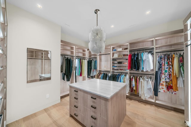 973 W Sipala Trl, Ivins, UT 84738 - spacious closet featuring a notable chandelier and light hardwood / wood-style flooring
