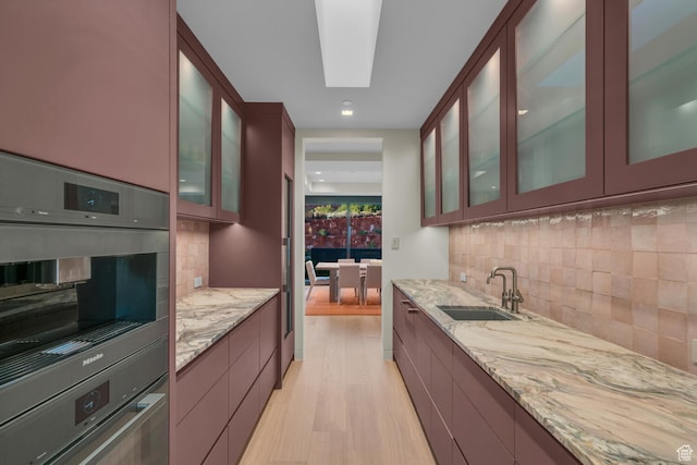 973 W Sipala Trl, Ivins, UT 84738 - kitchen with light stone counters, sink, and decorative backsplash
