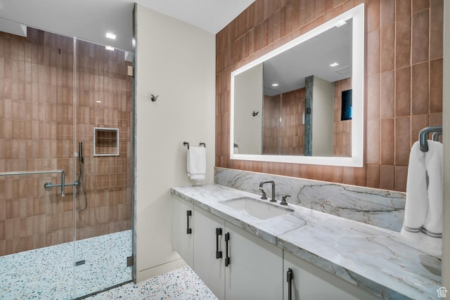 973 W Sipala Trl, Ivins, UT 84738 - bathroom with walk in shower, vanity, and tile walls