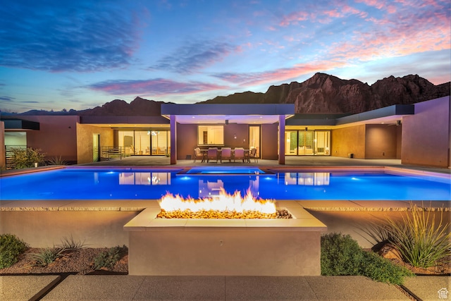 973 W Sipala Trl, Ivins, UT 84738 - pool at dusk featuring a patio and a fire pit