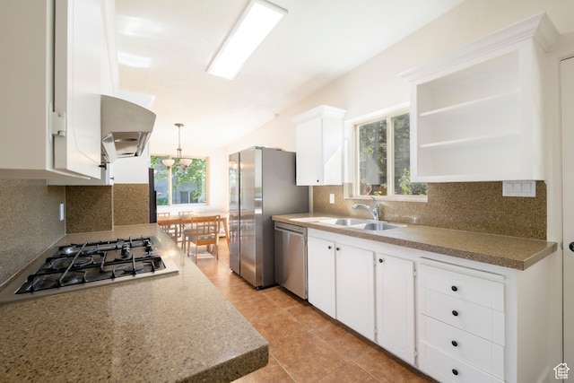 kitchen with appliances with stainless steel finishes, plenty of natural light, sink, and white cabinets