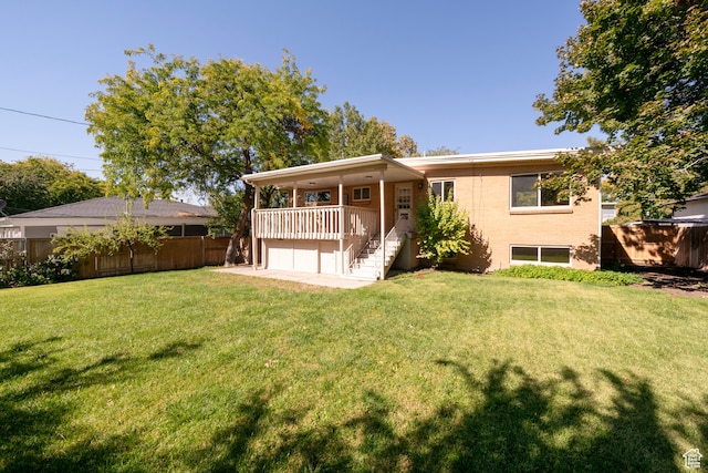 rear view of property featuring a yard