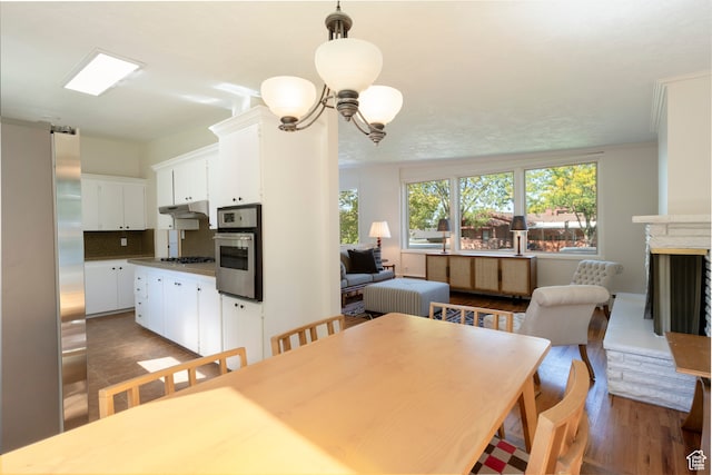 dining area featuring ornamental molding and dark hardwood / wood-style floors