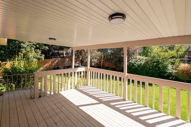 wooden terrace with a lawn