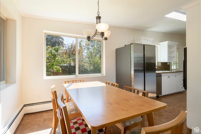 dining space featuring light tile patterned floors, crown molding, and an inviting chandelier