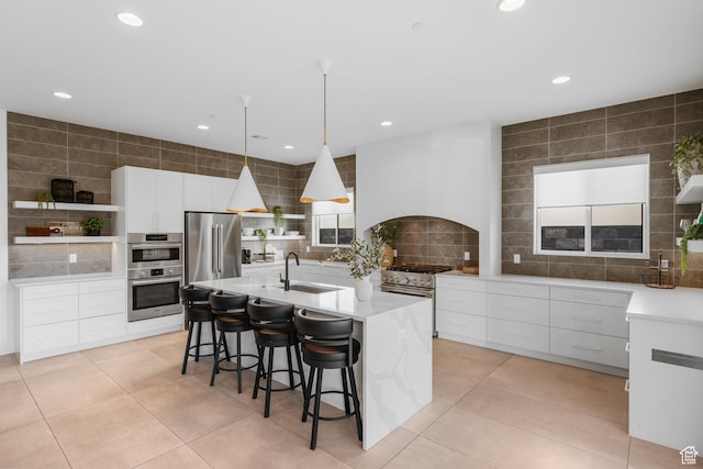 3617 S Cypress Point Rd, Hurricane, UT 84737 - kitchen featuring pendant lighting, white cabinetry, an island with sink, sink, and high end appliances