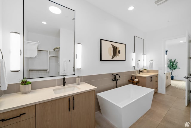 3617 S Cypress Point Rd, Hurricane, UT 84737 - bathroom with tile patterned flooring, vanity, a washtub, and tile walls