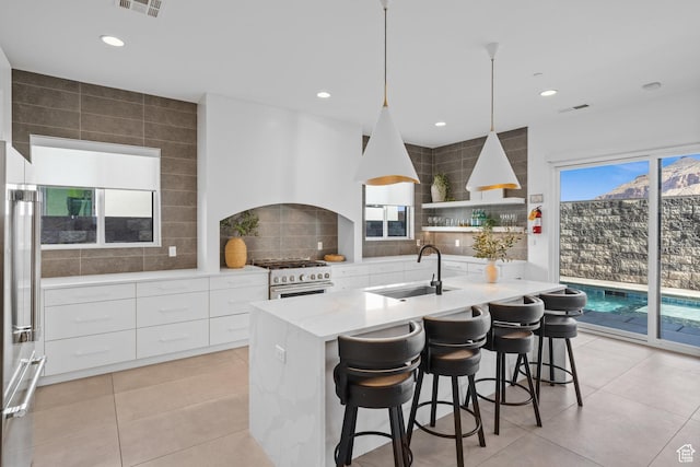3617 S Cypress Point Rd, Hurricane, UT 84737 - kitchen with high end appliances, sink, white cabinets, and an island with sink