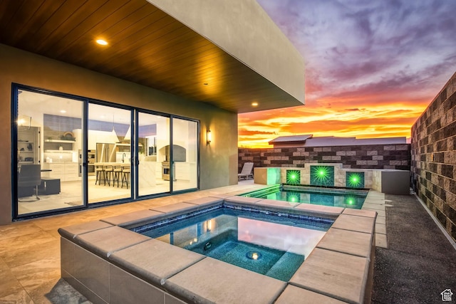 3617 S Cypress Point Rd, Hurricane, UT 84737 - pool at dusk featuring an in ground hot tub and a patio