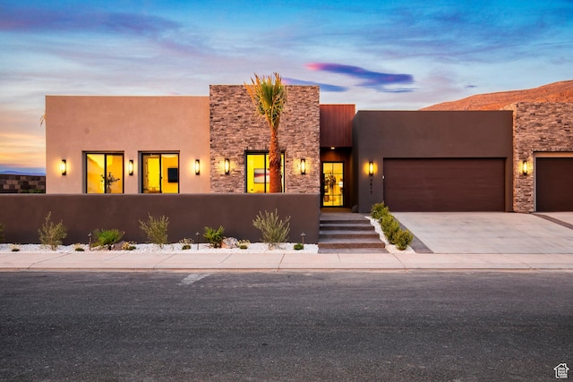 pueblo-style house with a garage