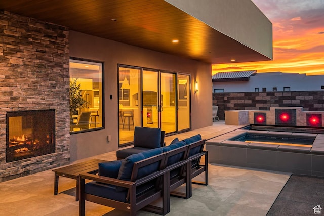 3617 S Cypress Point Rd, Hurricane, UT 84737 - patio terrace at dusk with an outdoor living space with a fireplace and an in ground hot tub