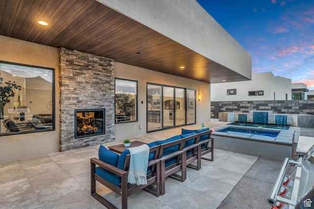 3617 S Cypress Point Rd, Hurricane, UT 84737 - patio terrace at dusk with an outdoor living space with a fireplace and a hot tub
