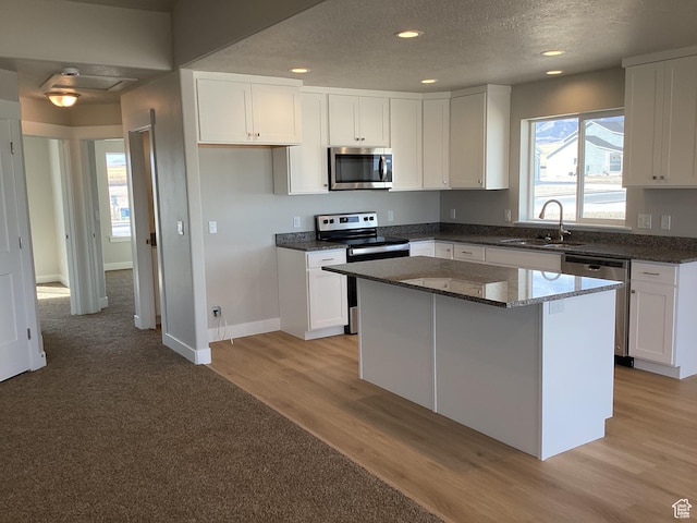 796 W Cherry Orchard Ln S, Grantsville, UT 84029 - kitchen featuring a sink, white cabinets, appliances with stainless steel finishes, and dark stone countertops