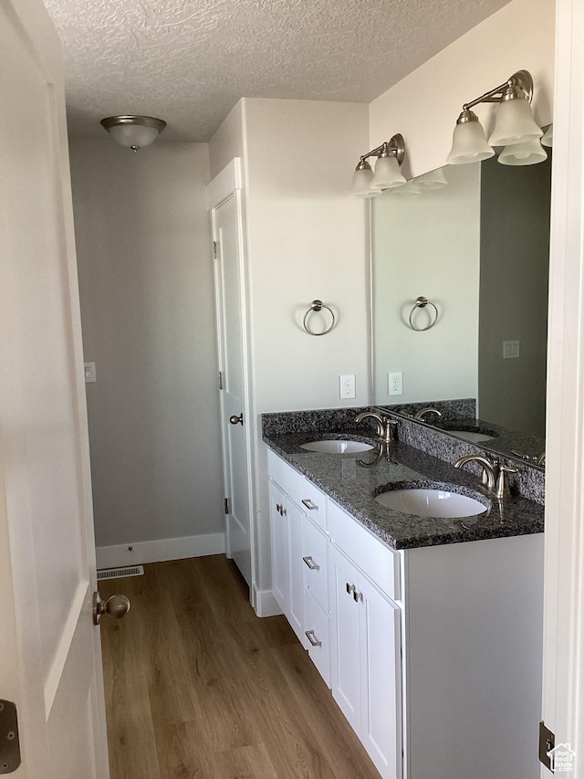796 W Cherry Orchard Ln S, Grantsville, UT 84029 - full bath featuring a textured ceiling, wood finished floors, double vanity, and a sink