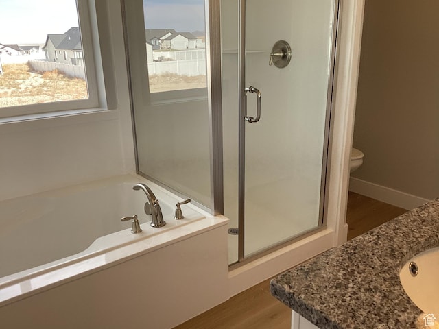 796 W Cherry Orchard Ln S, Grantsville, UT 84029 - bathroom featuring vanity, a garden tub, a stall shower, and wood finished floors