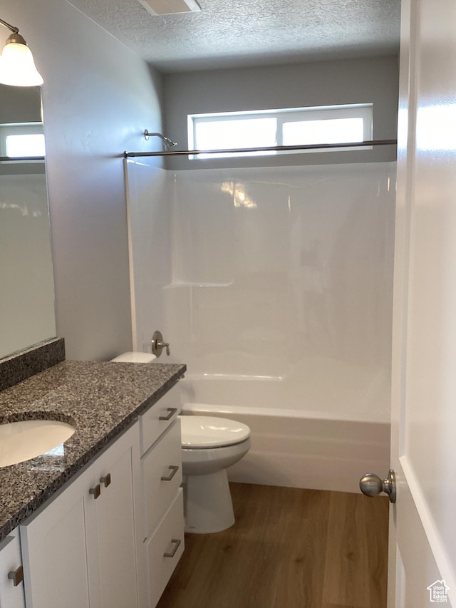 796 W Cherry Orchard Ln S, Grantsville, UT 84029 - full bathroom with shower / bathtub combination, a textured ceiling, vanity, toilet, and wood finished floors