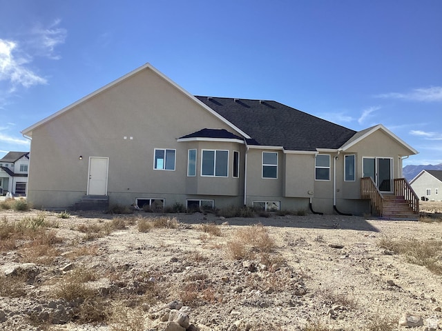 796 W Cherry Orchard Ln S, Grantsville, UT 84029 - back of property with a shingled roof and stucco siding