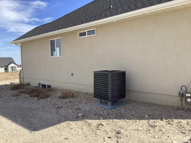796 W Cherry Orchard Ln S, Grantsville, UT 84029 - view of side of home with cooling unit, a shingled roof, and stucco siding