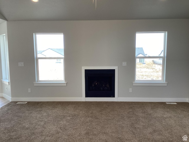 796 W Cherry Orchard Ln S, Grantsville, UT 84029 - unfurnished living room with visible vents, baseboards, and carpet flooring