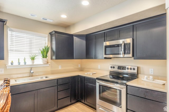 1485 W 350 N, Springville, UT 84663 - kitchen with visible vents, recessed lighting, light countertops, a sink, and appliances with stainless steel finishes