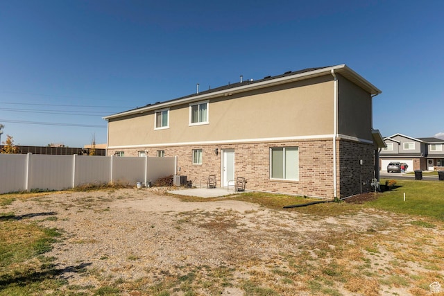 1485 W 350 N, Springville, UT 84663 - rear view of house featuring fence, brick siding, stucco siding, central AC unit, and a patio