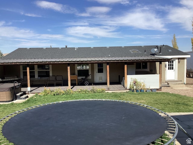 1528 E Valley View Dr, Manila, UT 84046 - rear view of property with a lawn, roof with shingles, stucco siding, and a hot tub