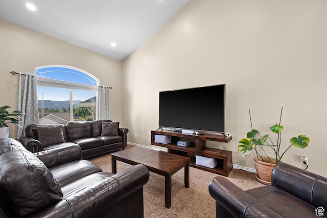 carpeted living area featuring recessed lighting, baseboards, and high vaulted ceiling