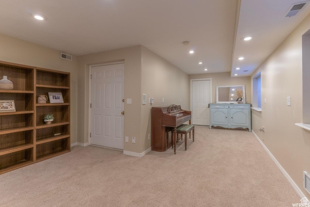 interior space featuring visible vents, recessed lighting, and light colored carpet