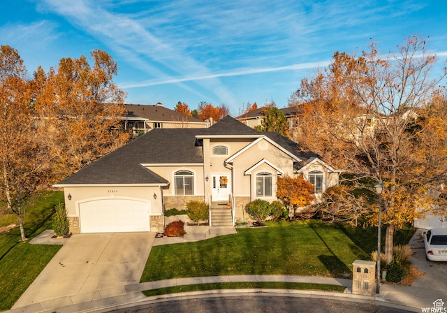 single story home with an attached garage, a front lawn, stone siding, stucco siding, and driveway