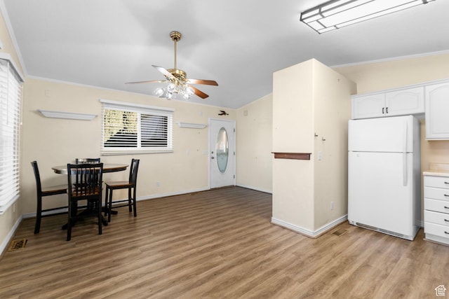 53 Pioneer Way, Hurricane, UT 84737 - kitchen featuring freestanding refrigerator, ceiling fan, white cabinets, light wood-style floors, and crown molding