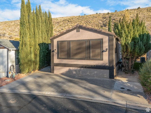 53 Pioneer Way, Hurricane, UT 84737 - view of front of house with stucco siding and a mountain view