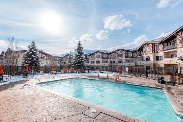 community pool featuring a patio and fence