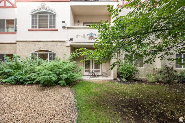 back of house with central AC unit, a patio area, and stucco siding