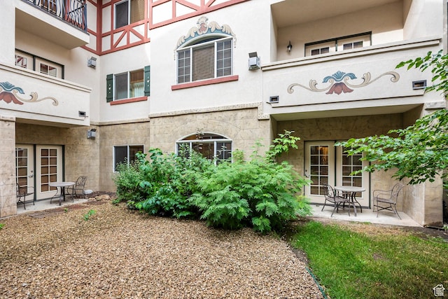 back of property featuring stucco siding