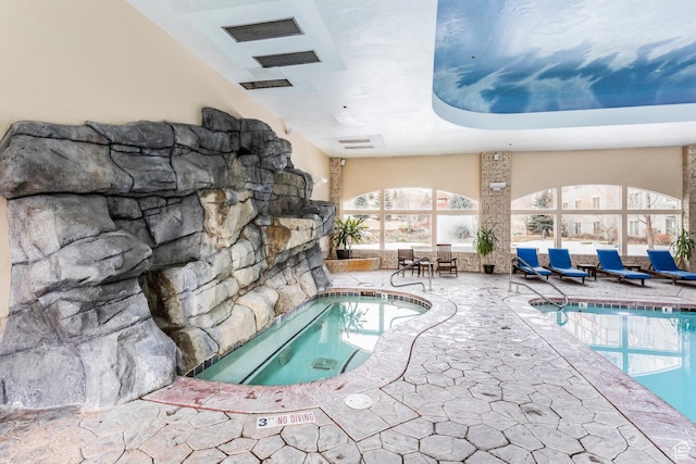 pool with an indoor in ground hot tub
