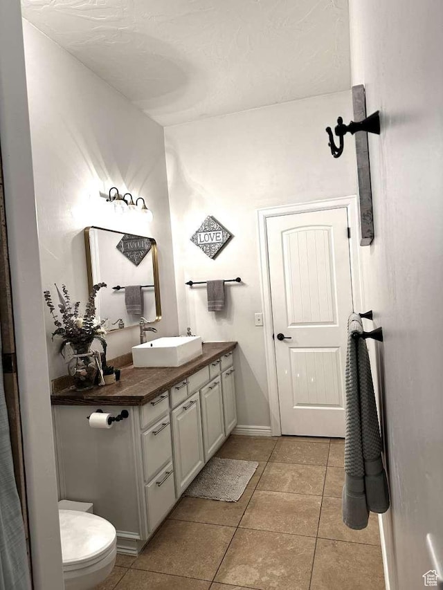 1350 E 600 S, Richfield, UT 84701 - bathroom with toilet, tile patterned floors, vanity, and baseboards