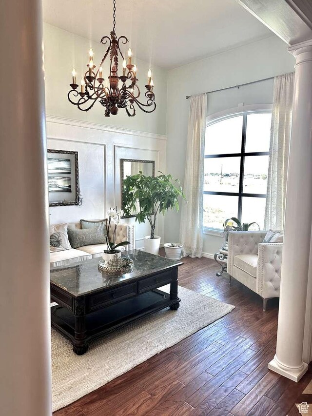 1350 E 600 S, Richfield, UT 84701 - living room with a notable chandelier, ornate columns, baseboards, and dark wood finished floors