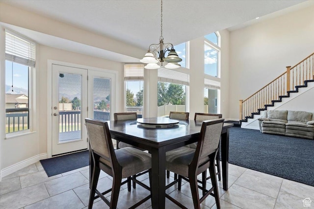 dining area with light tile patterned floors, a notable chandelier, stairway, and baseboards